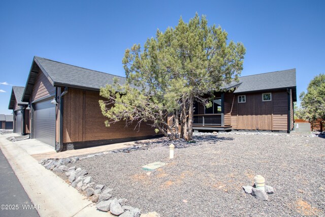 2071 N Bison Pass Ct, Show Low, AZ 85901 - view of front of property with a garage, a deck, and central AC unit
