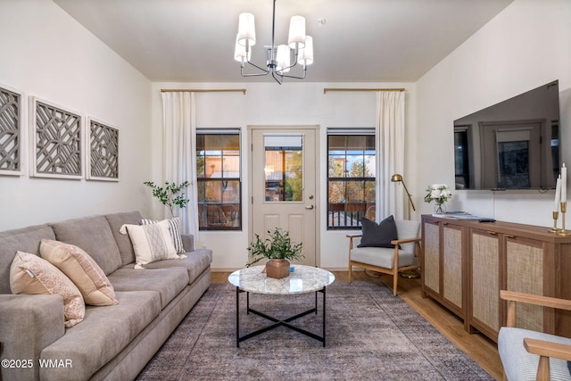living area featuring a chandelier and wood finished floors