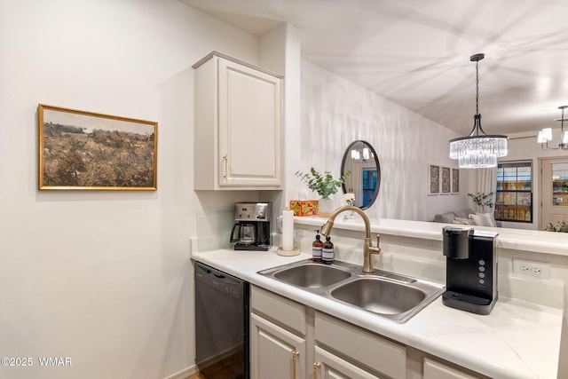 kitchen with light countertops, black dishwasher, an inviting chandelier, and a sink