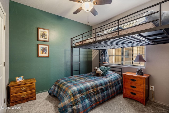 2385 Quarter Horse Trl, Overgaard, AZ 85933 - bedroom with carpet floors, a textured wall, and a ceiling fan