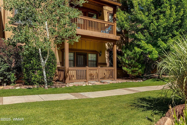 2385 Quarter Horse Trl, Overgaard, AZ 85933 - view of front of property with a balcony, board and batten siding, a front yard, and covered porch