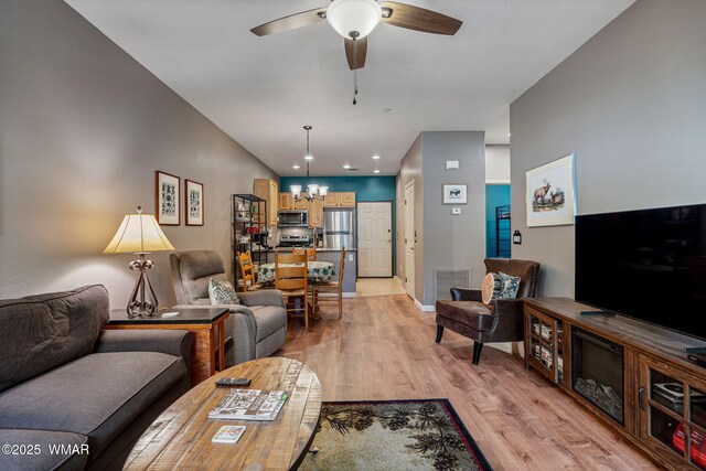 2385 Quarter Horse Trl, Overgaard, AZ 85933 - living room with a chandelier, a ceiling fan, light wood-type flooring, and recessed lighting