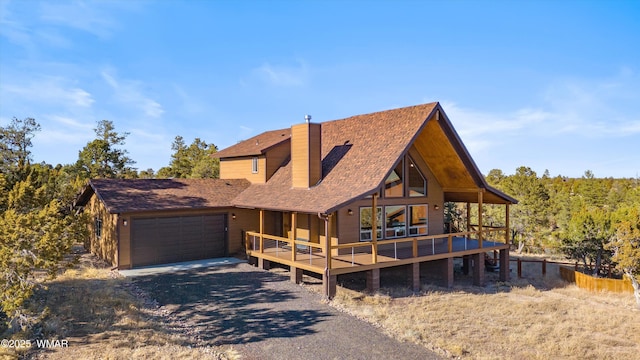 3457 Carefree Rd, Heber, AZ 85928 - view of front of home featuring a chimney, dirt driveway, a deck, an attached garage, and a shingled roof