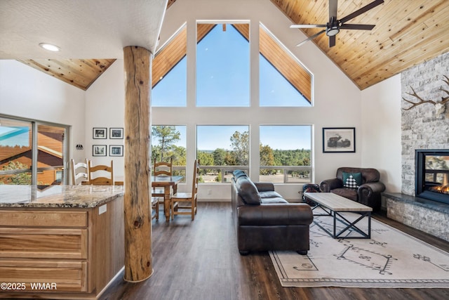 3457 Carefree Rd, Heber, AZ 85928 - living room featuring high vaulted ceiling, ceiling fan, a stone fireplace, dark wood finished floors, and wooden ceiling