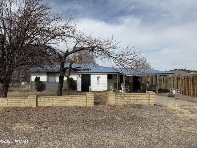 view of front of property with fence and metal roof