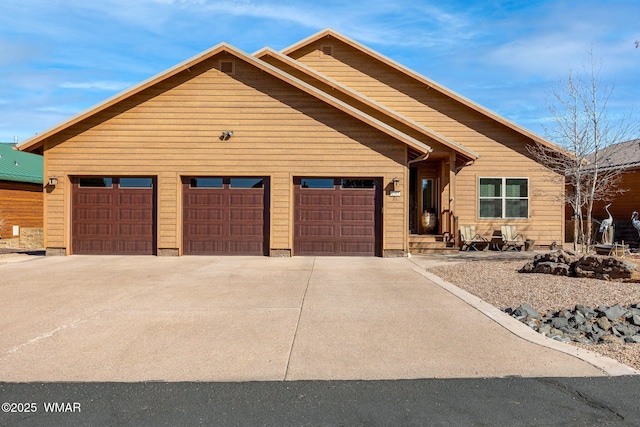 view of front of home with a garage and concrete driveway