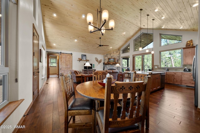 4611 Stonecrop Ln, Show Low, AZ 85901 - dining space with a barn door, wood ceiling, high vaulted ceiling, dark wood-type flooring, and a chandelier