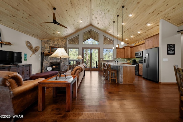 4611 Stonecrop Ln, Show Low, AZ 85901 - living room with a fireplace, wooden ceiling, vaulted ceiling, dark wood-style flooring, and a ceiling fan