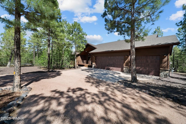 4611 Stonecrop Ln, Show Low, AZ 85901 - view of side of property with a garage, concrete driveway, and roof with shingles