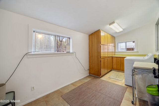 laundry room featuring cabinet space, baseboards, and separate washer and dryer