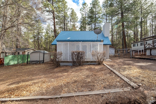 exterior space featuring fence and an outdoor structure