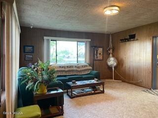 sitting room with carpet floors and wood walls