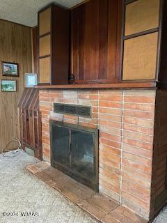 interior space with wood walls and a fireplace