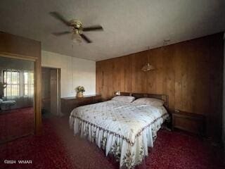 bedroom with dark colored carpet and wooden walls