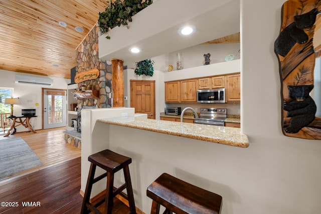 1601 N Stagecoach Cir, Show Low, AZ 85901 - kitchen featuring appliances with stainless steel finishes, wood ceiling, a wall unit AC, recessed lighting, and a breakfast bar area