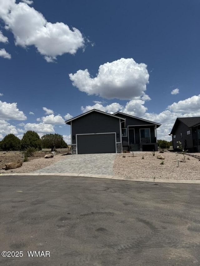 881 S Ridgeway Pl, Show Low, AZ 85901 - view of front of property with an attached garage, decorative driveway, and stone siding