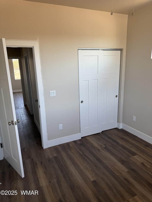 881 S Ridgeway Pl, Show Low, AZ 85901 - unfurnished bedroom featuring dark wood-type flooring and a closet