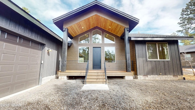 view of exterior entry with crawl space and an attached garage