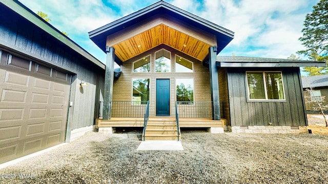 entrance to property with a garage and crawl space