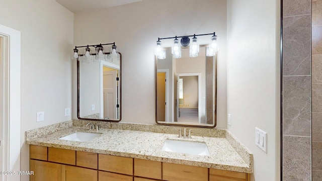 full bath with double vanity and a sink