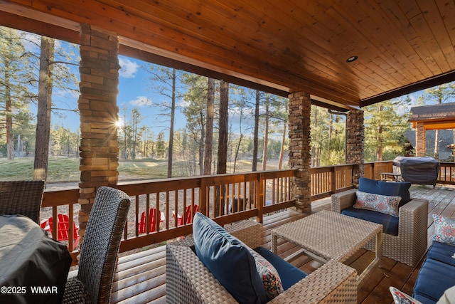 sunroom featuring plenty of natural light, lofted ceiling, and wooden ceiling