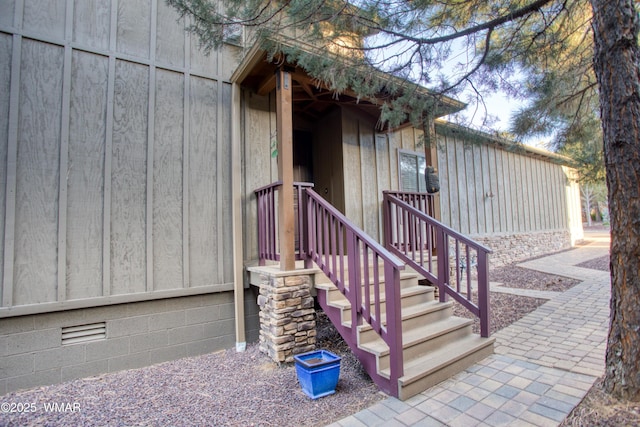 entrance to property featuring crawl space and board and batten siding