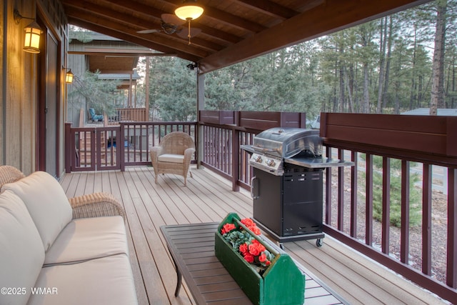 wooden terrace featuring a ceiling fan and grilling area