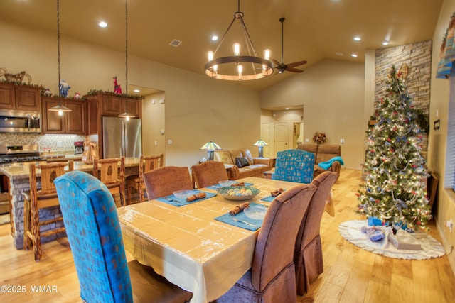 dining space featuring visible vents, high vaulted ceiling, recessed lighting, light wood-style floors, and a notable chandelier