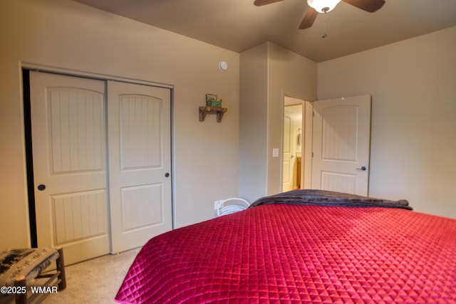 carpeted bedroom featuring a closet and ceiling fan