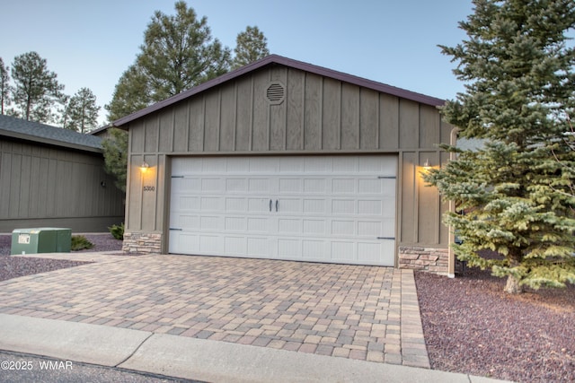 garage with decorative driveway