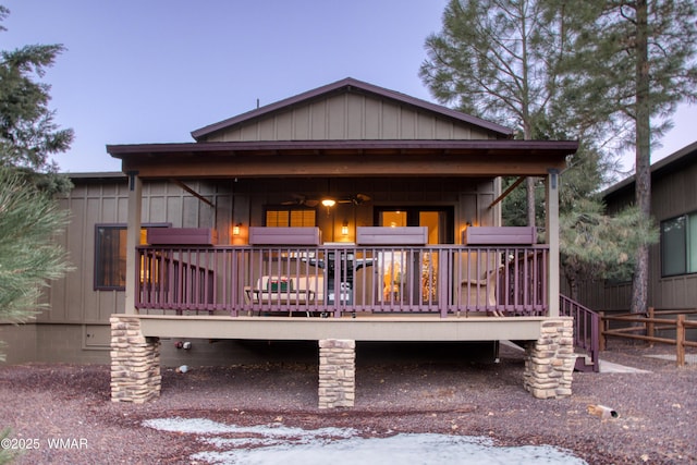 view of front of property featuring board and batten siding and a wooden deck