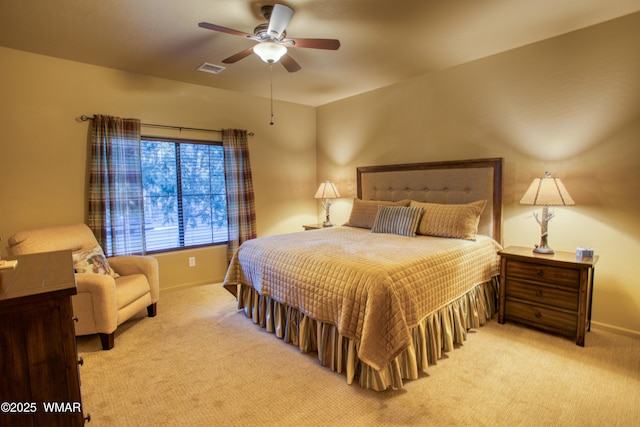 carpeted bedroom with visible vents, ceiling fan, and baseboards