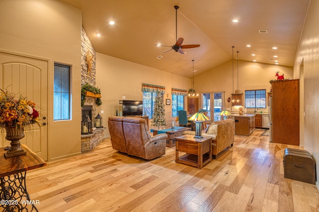 living area with a ceiling fan, visible vents, high vaulted ceiling, recessed lighting, and light wood-type flooring