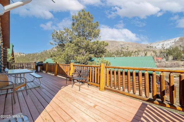 wooden deck with a mountain view