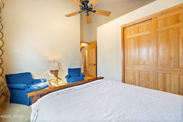 carpeted bedroom with a towering ceiling and a closet