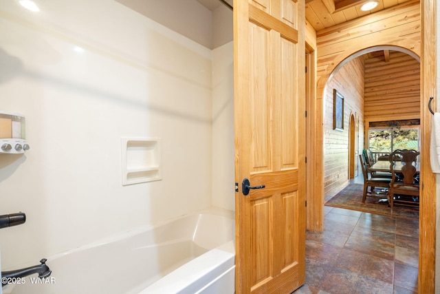 full bathroom featuring wood walls