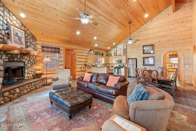 living room featuring arched walkways, wood ceiling, ceiling fan, a stone fireplace, and high vaulted ceiling