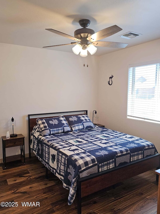 bedroom featuring visible vents, wood finished floors, and ceiling fan