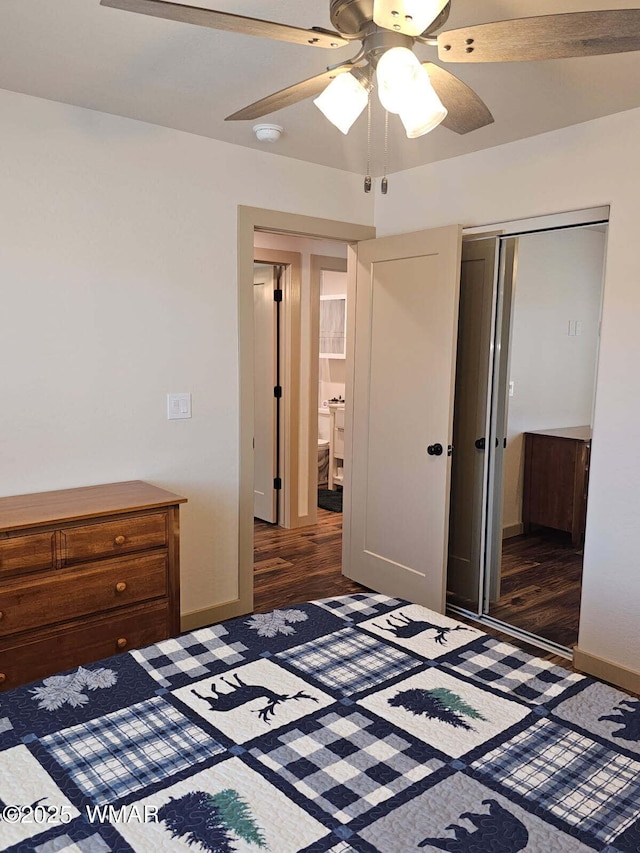 unfurnished bedroom featuring a closet, a ceiling fan, wood finished floors, and baseboards