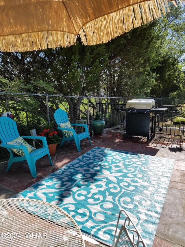 view of patio featuring grilling area and fence