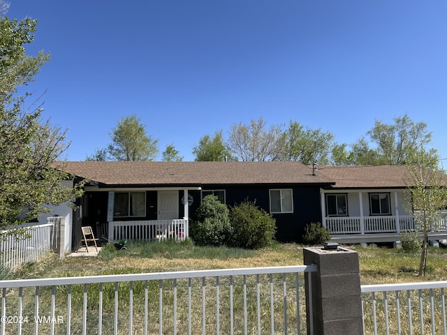 single story home with a fenced front yard and a porch