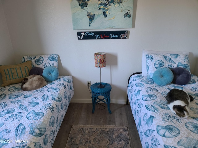 bedroom featuring dark wood-type flooring and baseboards