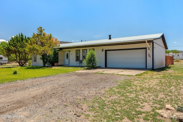 389 E 3rd St, Eagar, AZ 85925 - single story home with driveway, a metal roof, an attached garage, and a front lawn