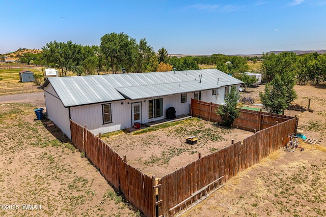 389 E 3rd St, Eagar, AZ 85925 - view of front of house with a metal roof, a fenced backyard, and a patio area