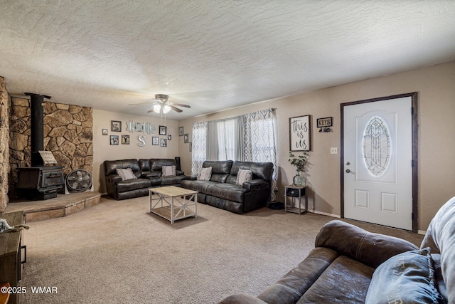 389 E 3rd St, Eagar, AZ 85925 - carpeted living room featuring ceiling fan, a wood stove, and a textured ceiling
