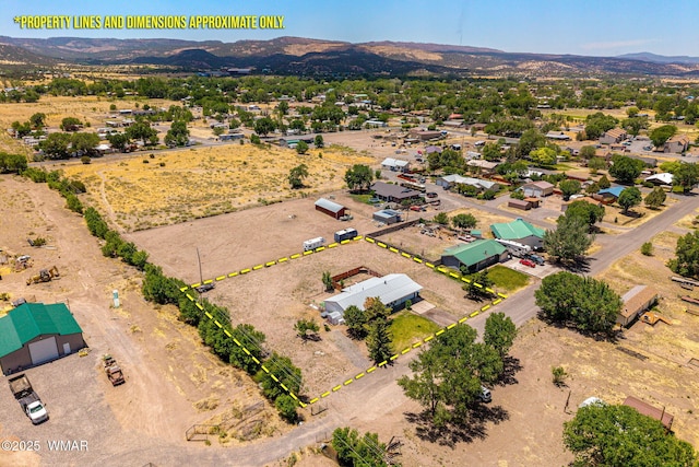 389 E 3rd St, Eagar, AZ 85925 - aerial overview of property's location with a mountainous background and property parcel outlined