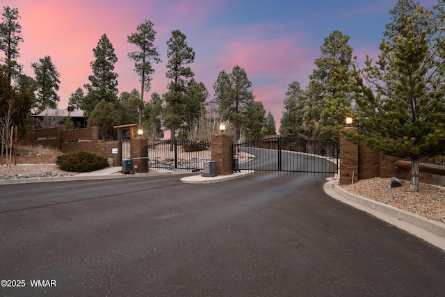 420 N Retreat Way, Show Low, AZ 85901 - view of asphalt road with a gate, curbs, and a gated entry