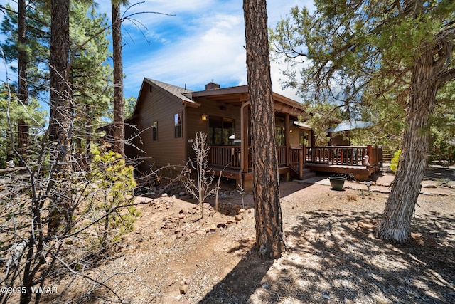420 N Retreat Way, Show Low, AZ 85901 - back of house featuring a chimney and a wooden deck