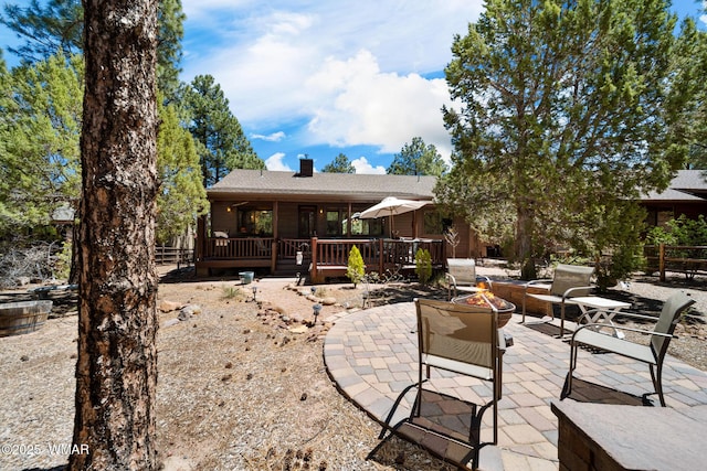 420 N Retreat Way, Show Low, AZ 85901 - back of property featuring an outdoor fire pit, a chimney, a deck, a patio area, and roof with shingles
