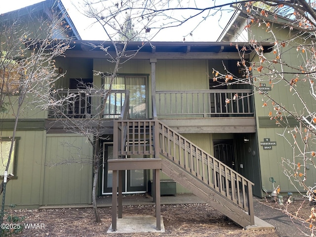 rear view of house featuring stairs